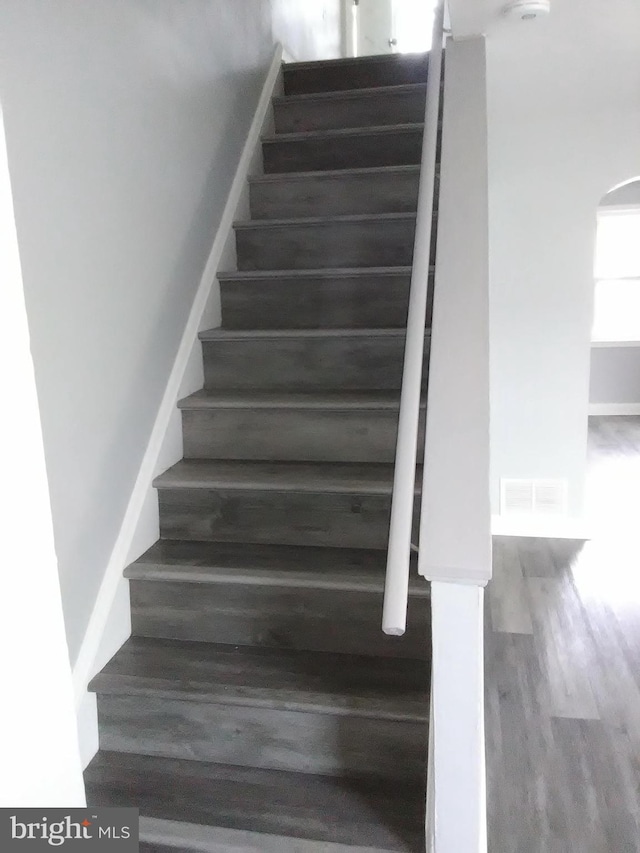 stairs with hardwood / wood-style flooring