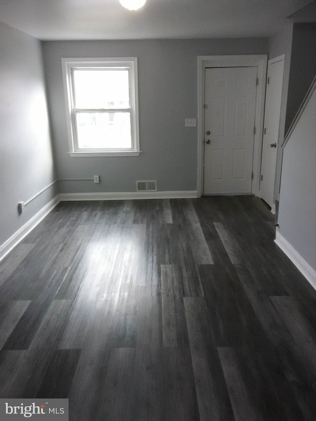 foyer entrance with dark hardwood / wood-style floors