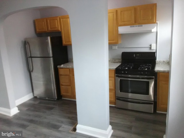 kitchen featuring appliances with stainless steel finishes and dark hardwood / wood-style flooring