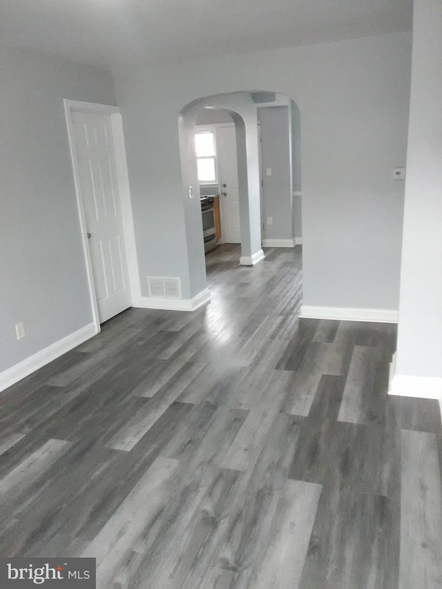 unfurnished room with dark hardwood / wood-style flooring