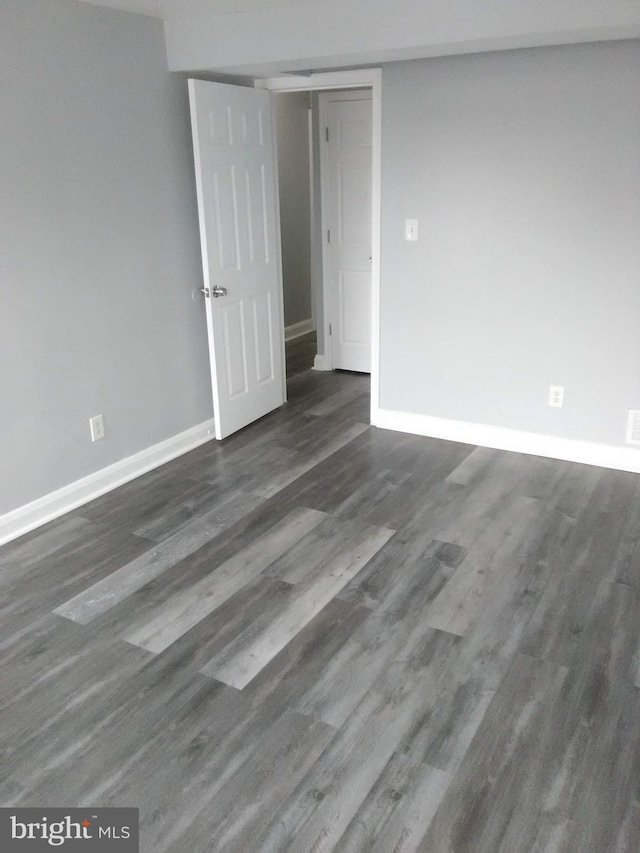 unfurnished room featuring dark hardwood / wood-style floors