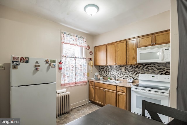 kitchen with sink, white appliances, radiator heating unit, and backsplash