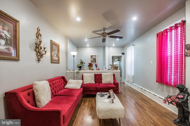 living room featuring dark wood-type flooring and ceiling fan