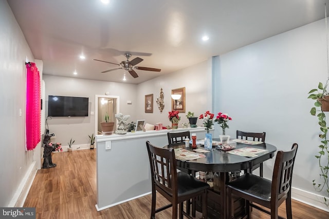 dining area featuring hardwood / wood-style flooring and ceiling fan