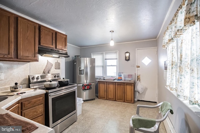 kitchen with pendant lighting, crown molding, stainless steel appliances, tasteful backsplash, and a textured ceiling