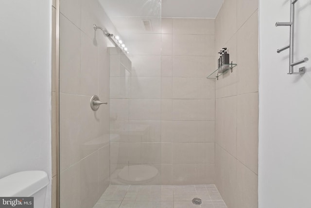 bathroom featuring toilet and tiled shower