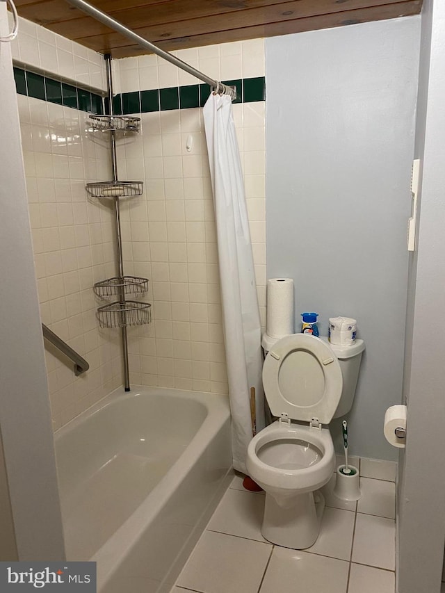 bathroom featuring tile patterned flooring, toilet, and shower / bath combo