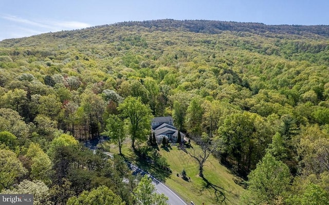 drone / aerial view featuring a forest view