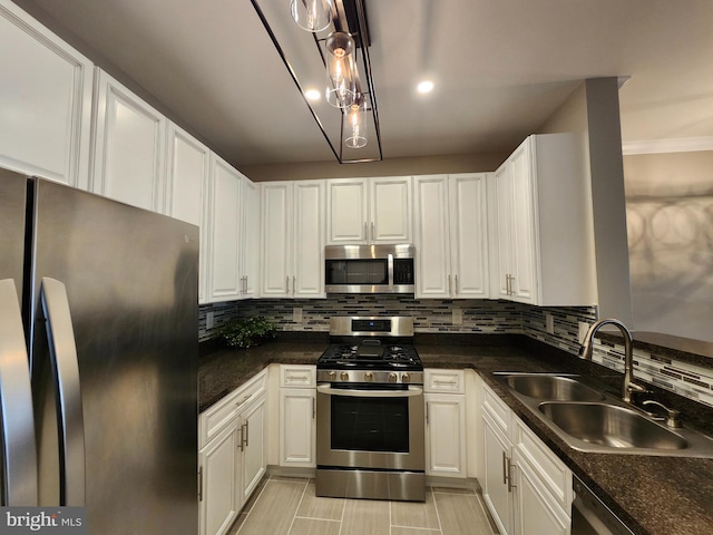 kitchen with white cabinetry, sink, decorative backsplash, and appliances with stainless steel finishes