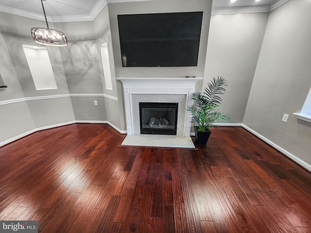 unfurnished living room with hardwood / wood-style flooring and crown molding