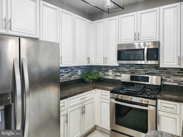 kitchen with white cabinetry, backsplash, and stainless steel appliances