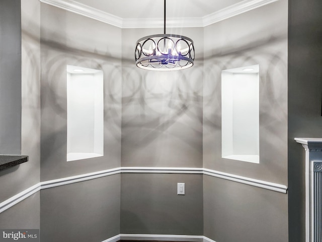 unfurnished dining area with ornamental molding and a notable chandelier