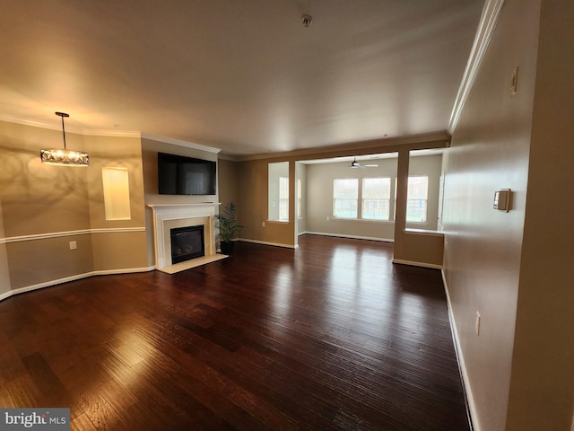 unfurnished living room with crown molding and dark hardwood / wood-style floors