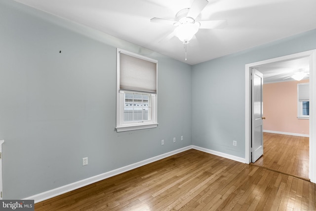 spare room with hardwood / wood-style flooring and ceiling fan