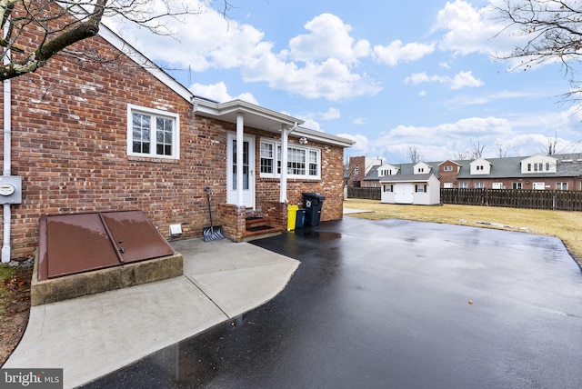 view of patio featuring a storage unit