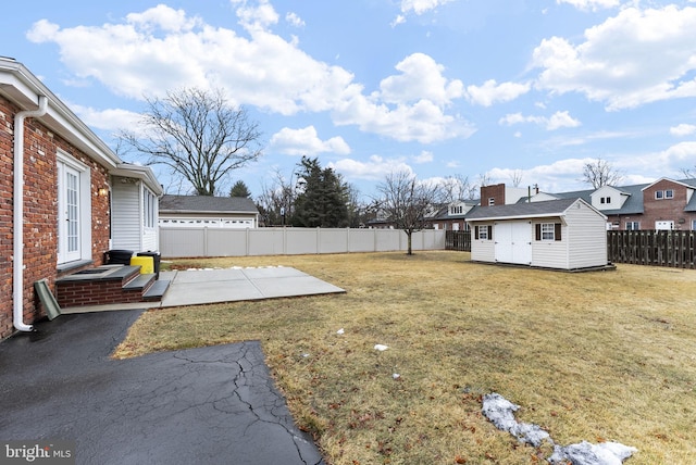 view of yard featuring a patio and an outdoor structure