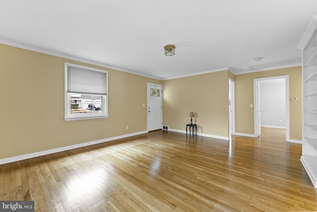 interior space featuring ornamental molding and light hardwood / wood-style floors