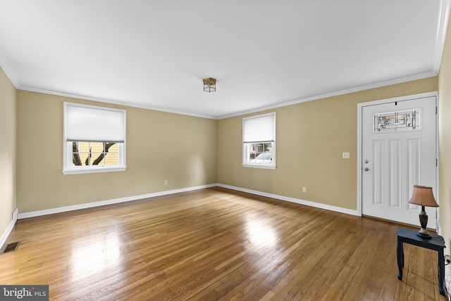 unfurnished living room with crown molding and wood-type flooring