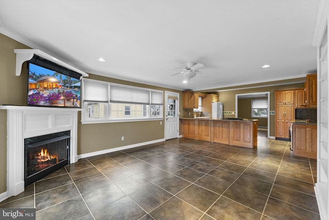 kitchen featuring fridge, dark tile patterned flooring, ceiling fan, kitchen peninsula, and ornamental molding