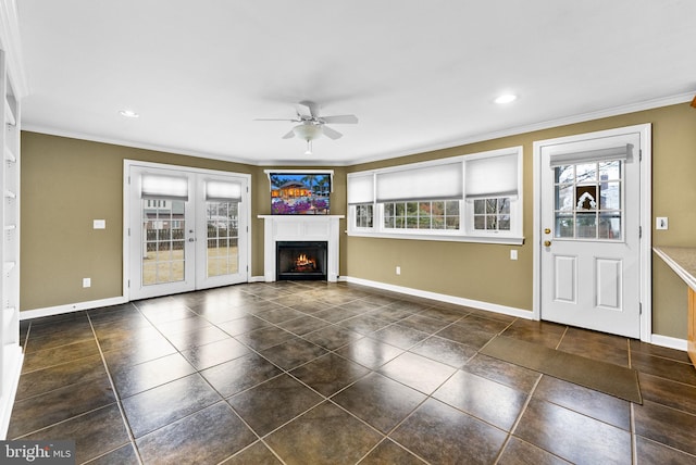 unfurnished living room featuring ceiling fan, crown molding, and french doors