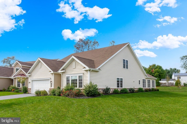 view of front of home with a garage and a front lawn