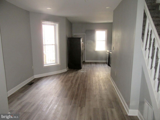 unfurnished living room with wood-type flooring