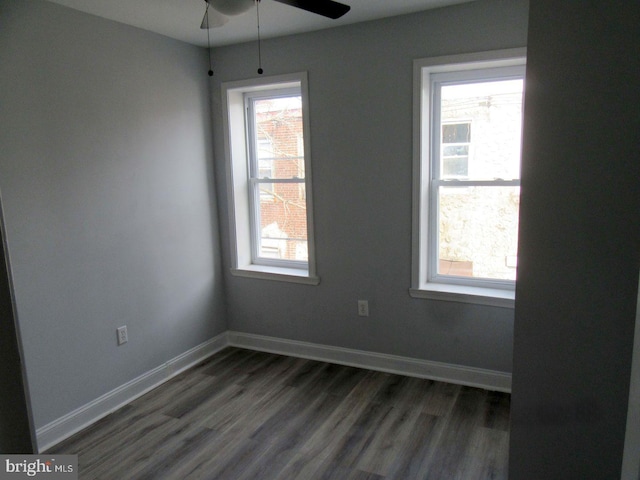 unfurnished room with ceiling fan and dark hardwood / wood-style floors