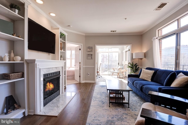 living room with dark hardwood / wood-style flooring, a fireplace, and a healthy amount of sunlight