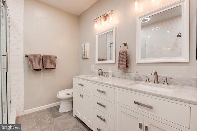 bathroom featuring vanity, toilet, and walk in shower