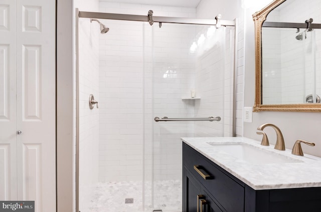 bathroom with an enclosed shower and vanity