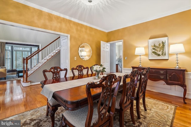 dining room featuring crown molding and hardwood / wood-style floors