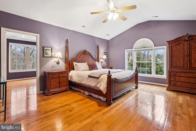 bedroom with vaulted ceiling, light hardwood / wood-style floors, and ceiling fan