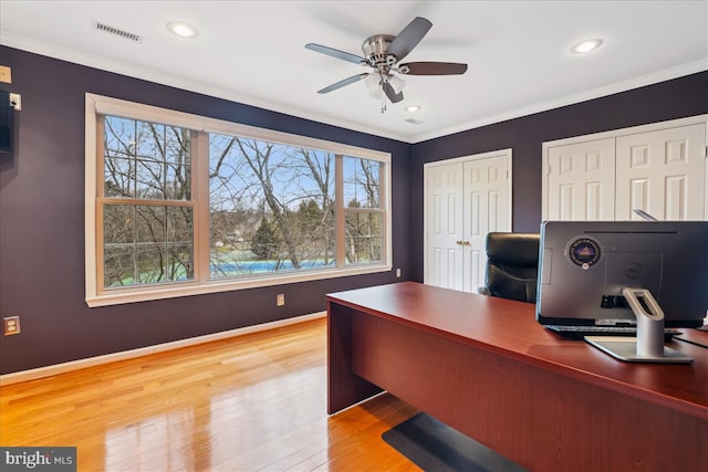 home office featuring crown molding, ceiling fan, and light hardwood / wood-style flooring