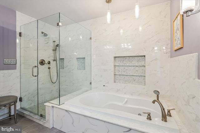 bathroom featuring plus walk in shower and tile walls