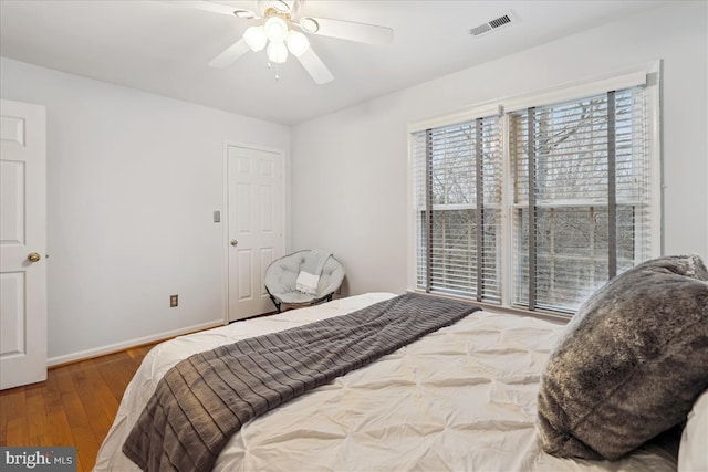 bedroom with ceiling fan and wood-type flooring