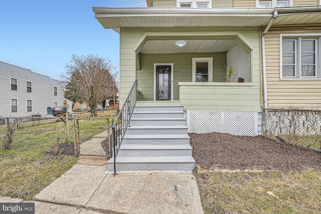 view of exterior entry with a porch