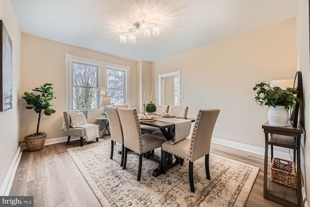 dining area featuring a notable chandelier and hardwood / wood-style flooring