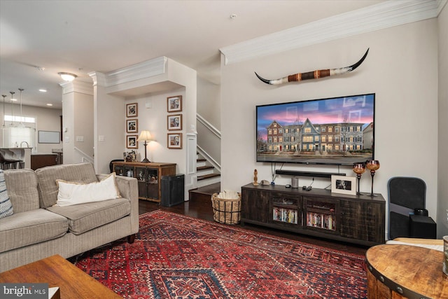 living room with crown molding and hardwood / wood-style floors