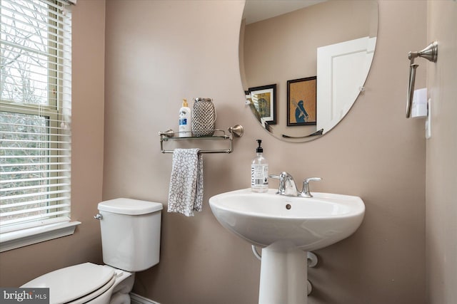 bathroom with plenty of natural light and toilet