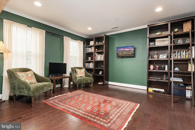 living area featuring dark hardwood / wood-style flooring and crown molding