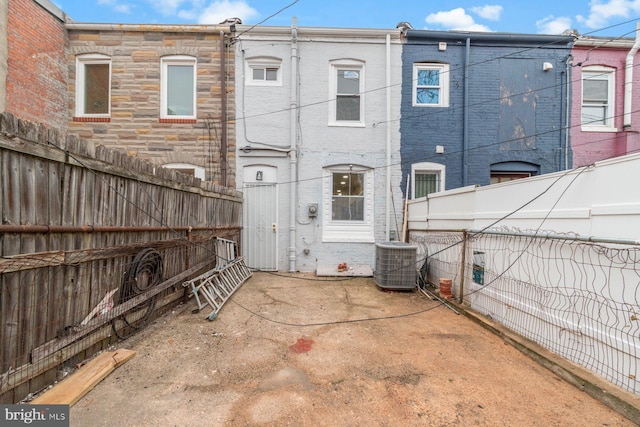 back of house with central air condition unit