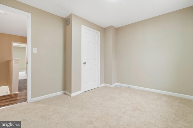 unfurnished bedroom featuring light carpet