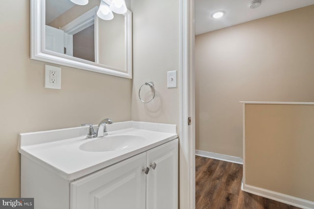 bathroom with hardwood / wood-style flooring and vanity