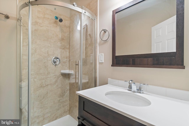 bathroom with vanity and a shower with shower door