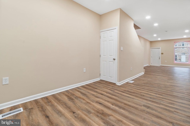 spare room featuring dark wood-type flooring