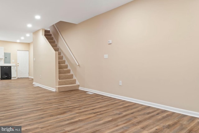 unfurnished living room featuring hardwood / wood-style flooring and electric panel