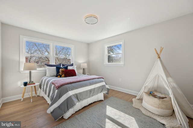 bedroom featuring baseboards and wood finished floors