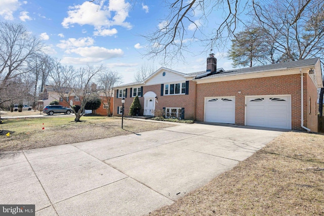 view of front of property with driveway, an attached garage, a chimney, and brick siding