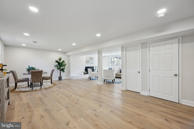 interior space with light wood-type flooring, baseboards, visible vents, and recessed lighting