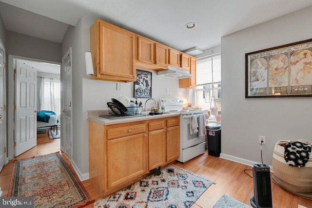 kitchen featuring white electric stove, light brown cabinetry, sink, and light hardwood / wood-style flooring